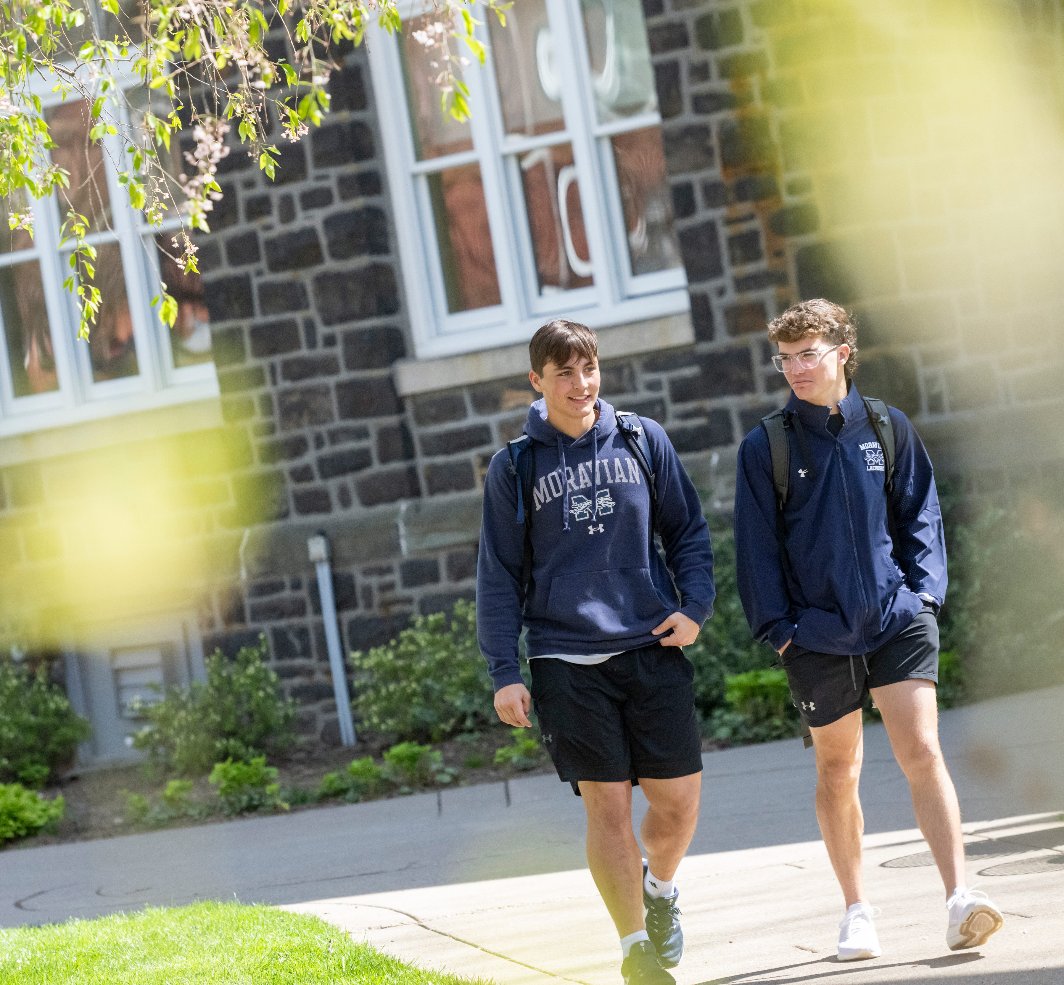 Two students walking on campus